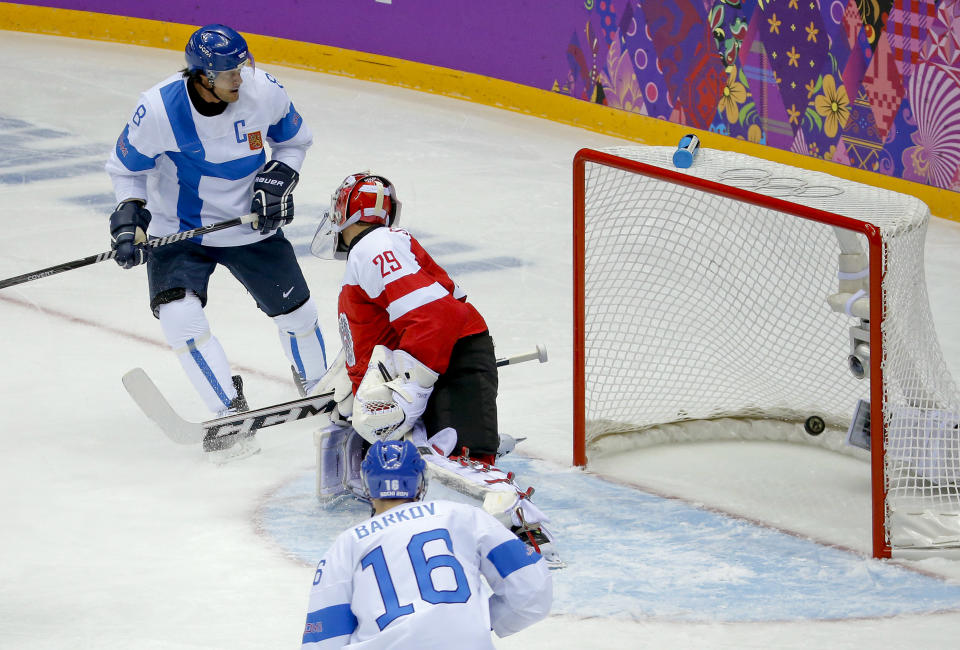 Finland forward Teemu Selanne (8) watches as the puck slips past Austria goaltender Bernhard Starkbaum for a goal in the first period of a men's ice hockey game at the 2014 Winter Olympics, Thursday, Feb. 13, 2014, in Sochi, Russia. (AP Photo/Mark Humphrey)