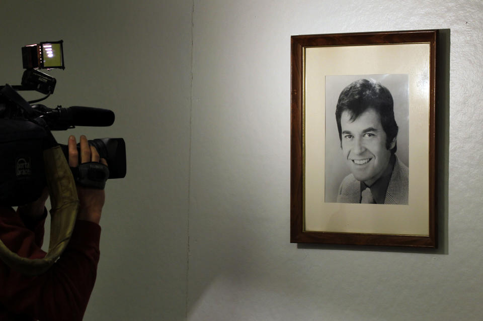 A television videographer photographs a picture of "American Bandstand" host Dick Clark at the Enterprise Center, Wednesday, April 18, 2012 in Philadelphia. The Enterprise Center is located in the former American Bandstand studios. Dick Clark, the ever-youthful television host and producer who helped bring rock 'n' roll into the mainstream on "American Bandstand" and rang in the New Year for the masses at Times Square died at 82. (AP Photo/Alex Brandon)