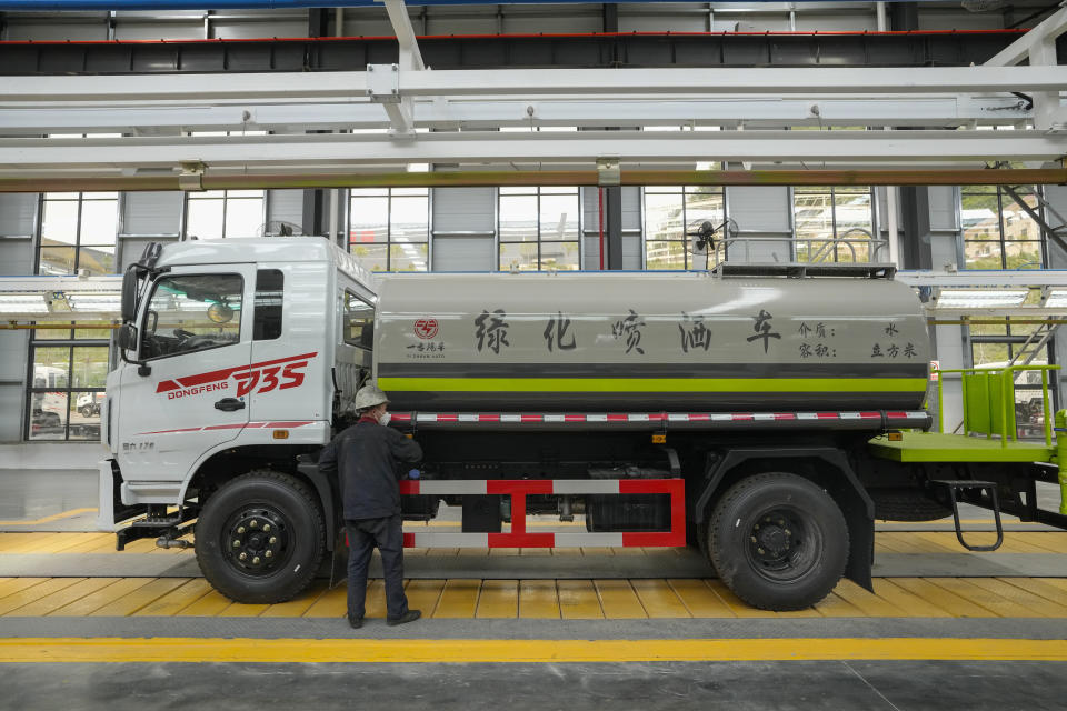 A worker assembles a liquid tanker truck at a Yizhuan Automobile Co. manufacturing factory during a media-organized tour in Shiyan city in central China's Hubei Province on May 12, 2023. China's manufacturing and consumer spending are weakening after a strong start to 2023 after anti-virus controls ended. (AP Photo/Andy Wong)