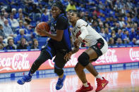 FILE - In this Dec. 15, 2019, file photo, Kentucky guard Rhyne Howard (10) dribbles past Louisville guard Elizabeth Balogun (4) during the first half of an NCAA basketball game in Lexington, Ky. Howard did nearly everything for Kentucky this season. The sophomore guard averaged 23.4 points, 6.5 rebounds and hit 84 3-pointers. Howard was selected to The Associated Press women's All-America first team, Thursday, March 19, 2020. (AP Photo/Bryan Woolston, File)