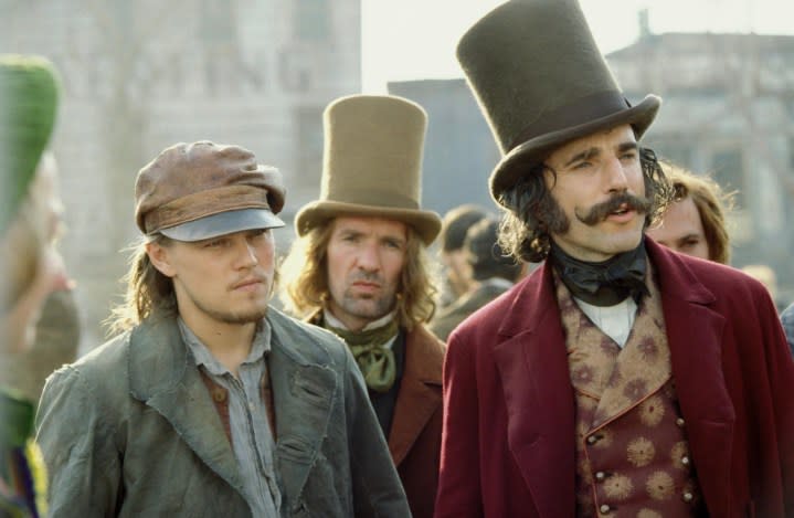 Two men stand next to each other and stare in. Gangs of New York.