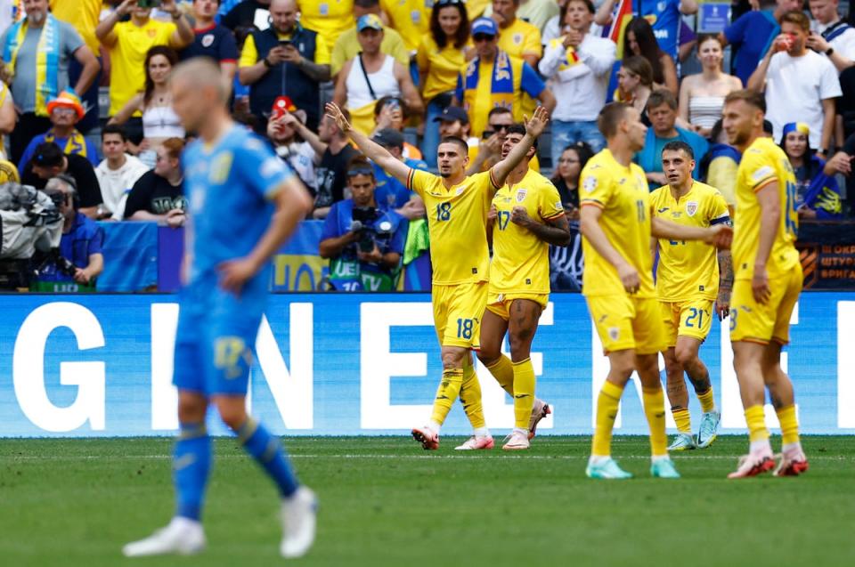 Romania’s Razvan Marin (18) celebrates scoring their second goal (Reuters)