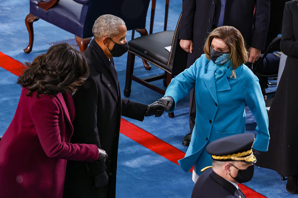 <p>The Obamas share a gloved greeting with Speaker of the House Nancy Pelosi. </p>
