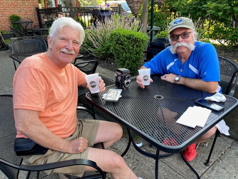 David Lilley, a retired Blendon Township police officer, and Tom Ullom, a retired Westerville firefighter, enjoy an adult beverage on the patio at Jimmy V’s Grill & Pub, 1 S. State St., during the May 16 kickoff of the Designated Outdoor Refreshment Area expansion.