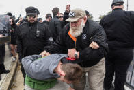 <p>A person thought to be an infiltrator is held by people participating in a “White Lives Matter” rally in Shelbyville, Tenn., Oct. 28, 2017. (Photo: Stephanie Keith/Reuters) </p>