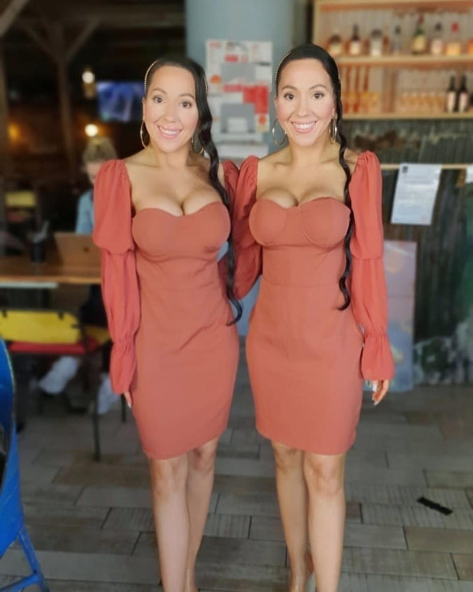 Identical twins Anna and Lucy DeCinque wearing matching pink dresses