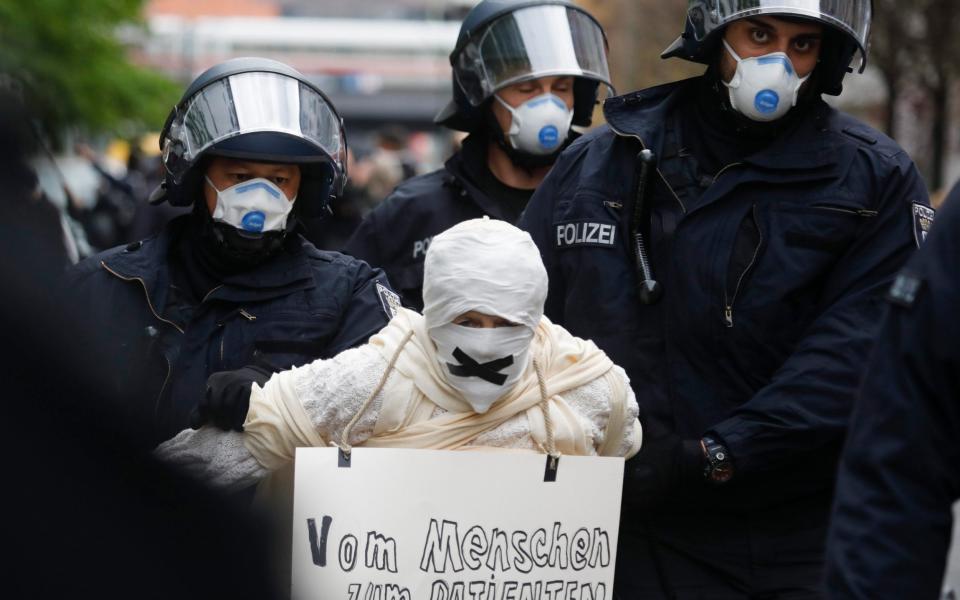 German police detain anti-lockdown protesters at a rally on Monday  - Markus Schreiber/AP