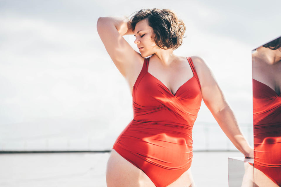 a woman standing in a bathing suit