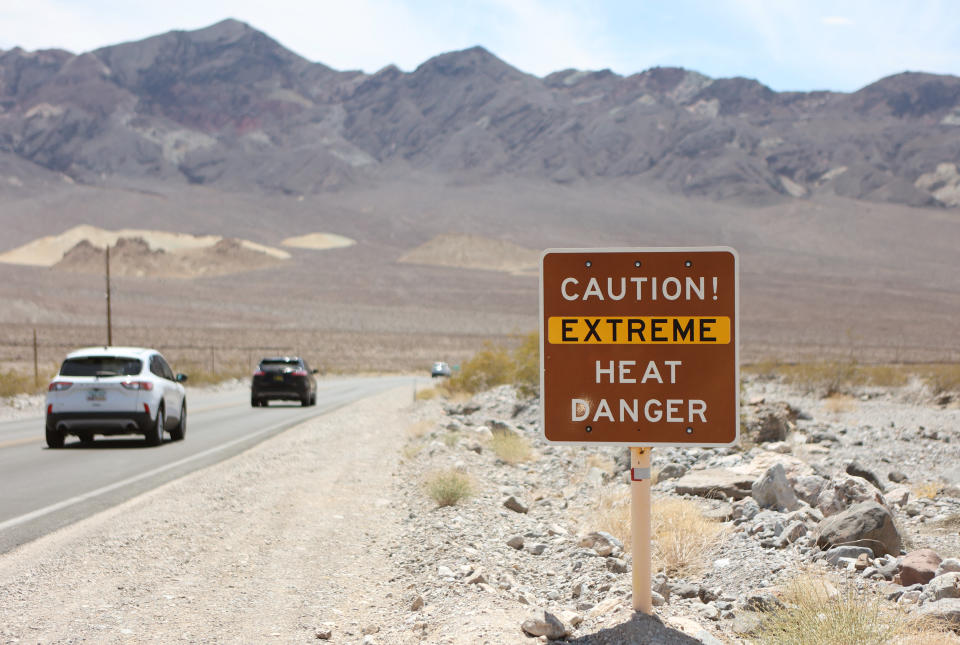 TOPSHOT - A heat advisory sign is shown along US highway 190 during a heat wave in Death Valley National Park in Death Valley, California, on July 16, 2023. Tens of millions of Americans braced for more sweltering temperatures Sunday as brutal conditions threatened to break records due to a relentless heat dome that has baked parts of the country all week. By the afternoon of July 15, 2023, California's famous Death Valley, one of the hottest places on Earth, had reached a sizzling 124F (51C), with Sunday's peak predicted to soar as high as 129F (54C). Even overnight lows there could exceed 100F (38C). (Photo by Ronda Churchill / AFP) (Photo by RONDA CHURCHILL/AFP via Getty Images)