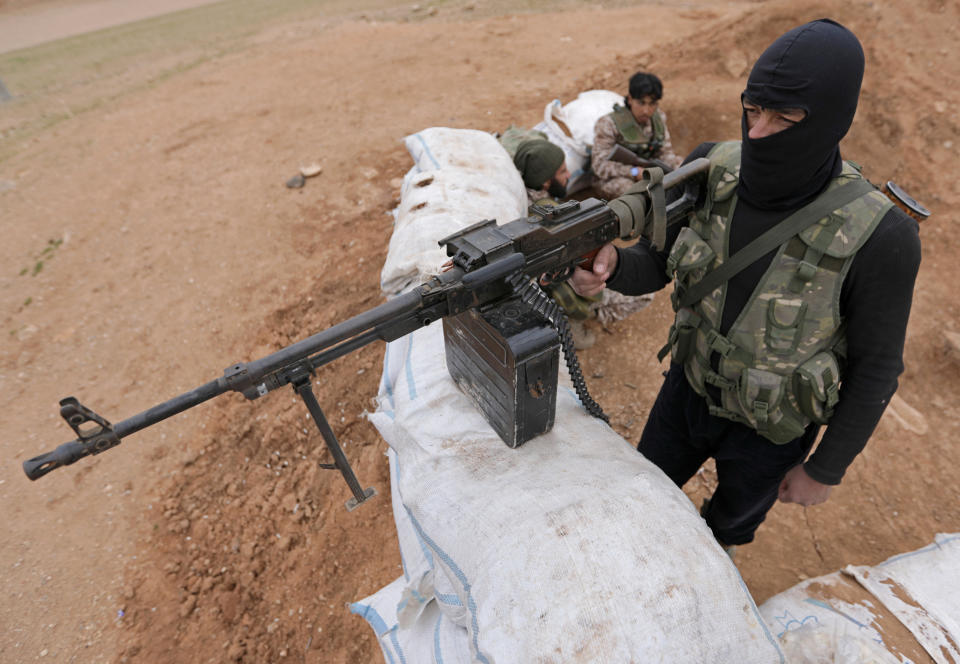 <p>Turkey-backed Free Syrian Army fighters are seen in al Ajami village in east al Bab, Syria, Feb. 3, 2018. (Photo: Khalil Ashawi/Reuters) </p>