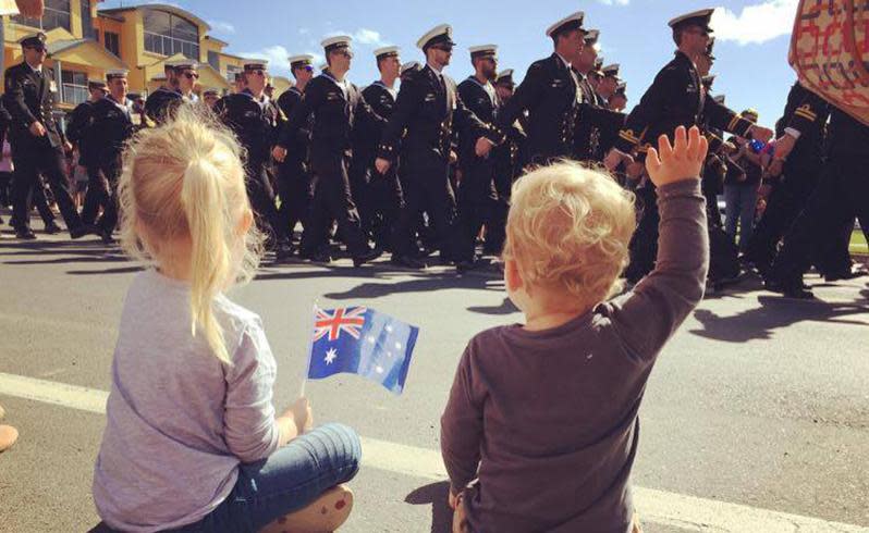 Two young children pay their respects to soldiers at Huskisson, Jervis Bay. Source: Emily Williams