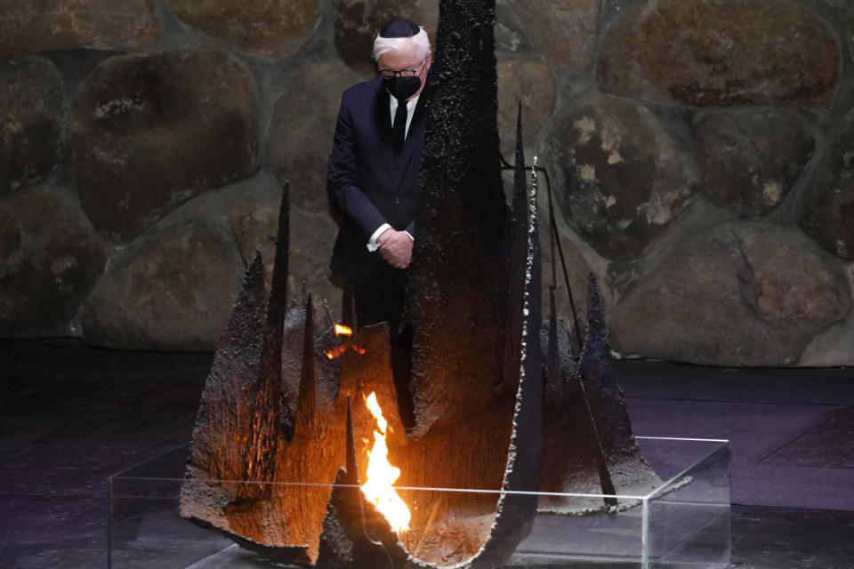 German President Frank-Walter Steinmeier rekindles the Eternal Flame in the Hall of Remembrance at the Yad Vashem Holocaust memorial in Jerusalem, Thursday, July 1, 2021. (AP Photo/Ariel Schalit)