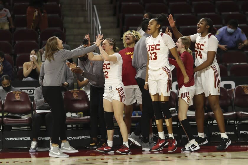 Southern California coach Lindsay Gottlieb, left, and players celebrate as they defeat Arizona.