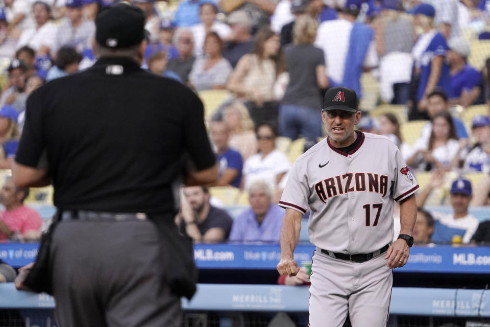 Arizona Diamondbacks manager Torey Lovullo, right, questions home plate umpire Tony Randazzo about a strikeout call during the first inning of a baseball game against the Los Angeles Dodgers Saturday, July 10, 2021, in Los Angeles. (AP Photo/Mark J. Terrill)