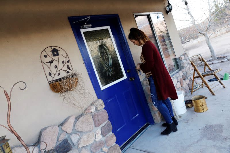 Kendra Miller opens door to her grandmother's abandoned house in La Mora