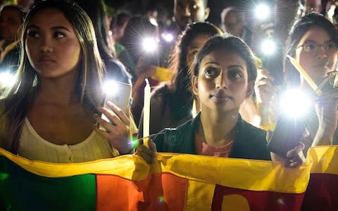 Members of the public join in an interfaith candlelight vigil during a Mass of Remembrance  - Credit: &nbsp;BIANCA DEMARCHI/REX