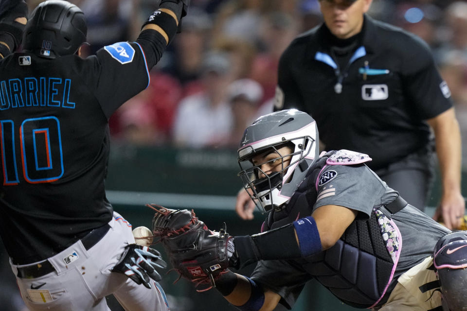 Washington Nationals catcher Keibert Ruiz, right, loses the ball as Miami Marlins' Yuli Gurriel scores during the eighth inning of a baseball game at Nationals Park, Friday, June 16, 2023, in Washington. The Marlins won 6-5. (AP Photo/Alex Brandon)