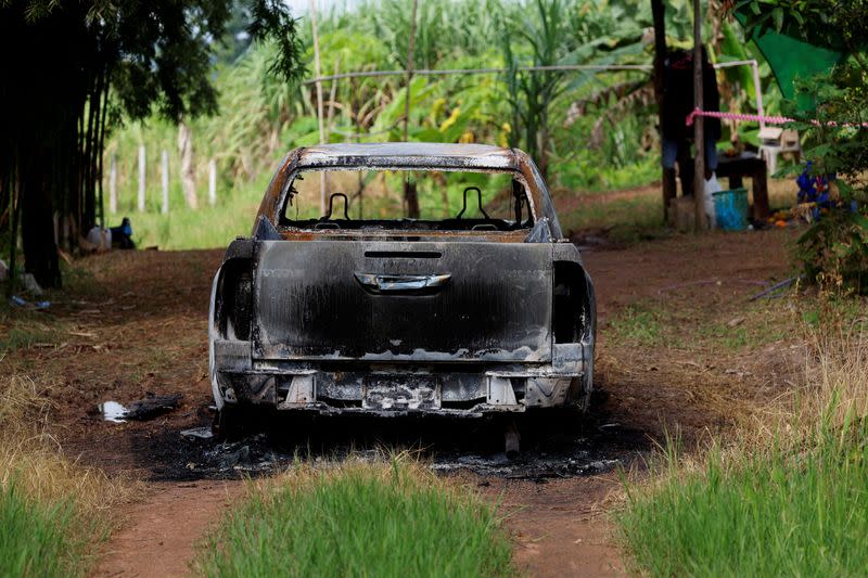 A burnt car is seen at the house of the shooter Panya Khamrap after the mass shooting in the town of Uthai Sawan, in the province of Nong Bua Lam Phu