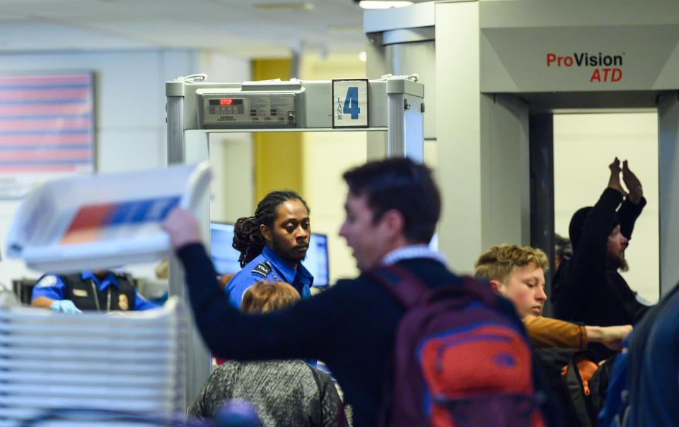 A Transportation Safety Administration (TSA) agent checks passengers at Ronald Reagan Washington National Airport in Arlington, Virginia, on January 24, 2019. - Air transport workers warned the five-week-old US government shutdown could cause US commercial aviation to collapse as they planned a protest in the US capital's National Airport. They also pointed to the lengthening of passenger inspection times in airports due to an increasing number of workers for the TSA not showing up. (Photo by Andrew CABALLERO-REYNOLDS / AFP)        (Photo credit should read ANDREW CABALLERO-REYNOLDS/AFP via Getty Images)