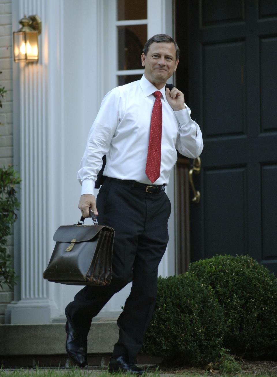 Chief Justice of the Supreme Court John Roberts leaves his house in 2005.