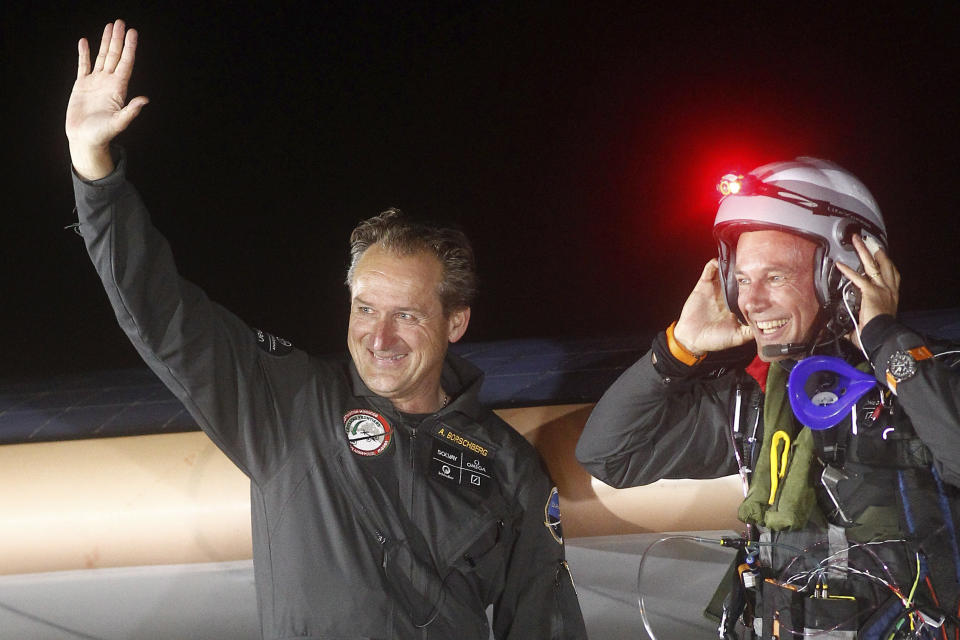 Solar Impulse pilots Bertrand Piccard, right, and Andre Borschberg, left, are all smiles upon arrival at Rabat airport, Morocco, Tuesday, June 5, 2012. The experimental solar-powered airplane landed in Morocco's capital late Tuesday after a 20-hour trip from Madrid in the first transcontinental flight by a craft of its type. The mission is being described as a final dress rehearsal for a round-the-world flight with a new and improved plane in 2014. (AP Photo/Abdeljalil Bounhar)