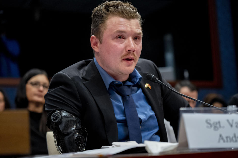 Former Marine Sgt. Tyler Vargas-Andrews, who was gravely injured, losing an arm and a leg in a suicide attack at Hamid Karzai International Airport in Kabul, becomes emotional as he recounts his story during a House Committee on Foreign Affairs hearing on the United States evacuation from Afghanistan on Capitol Hill in Washington, Wednesday, March 8, 2023. (AP Photo/Andrew Harnik)