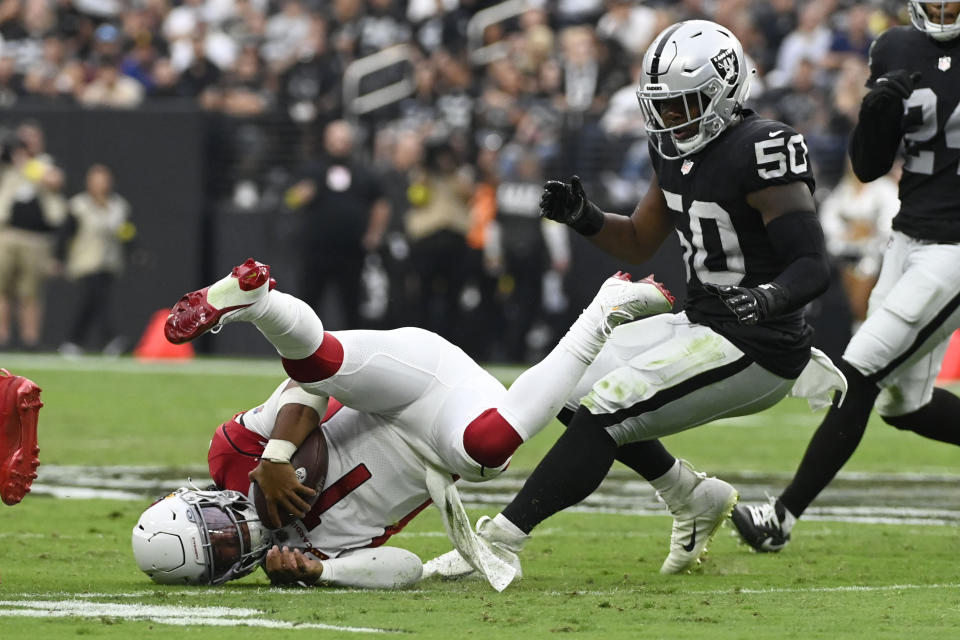 Arizona Cardinals quarterback Kyler Murray (1) falls down next to Las Vegas Raiders linebacker Jayon Brown (50) during the second half of an NFL football game Sunday, Sept. 18, 2022, in Las Vegas. (AP Photo/David Becker)