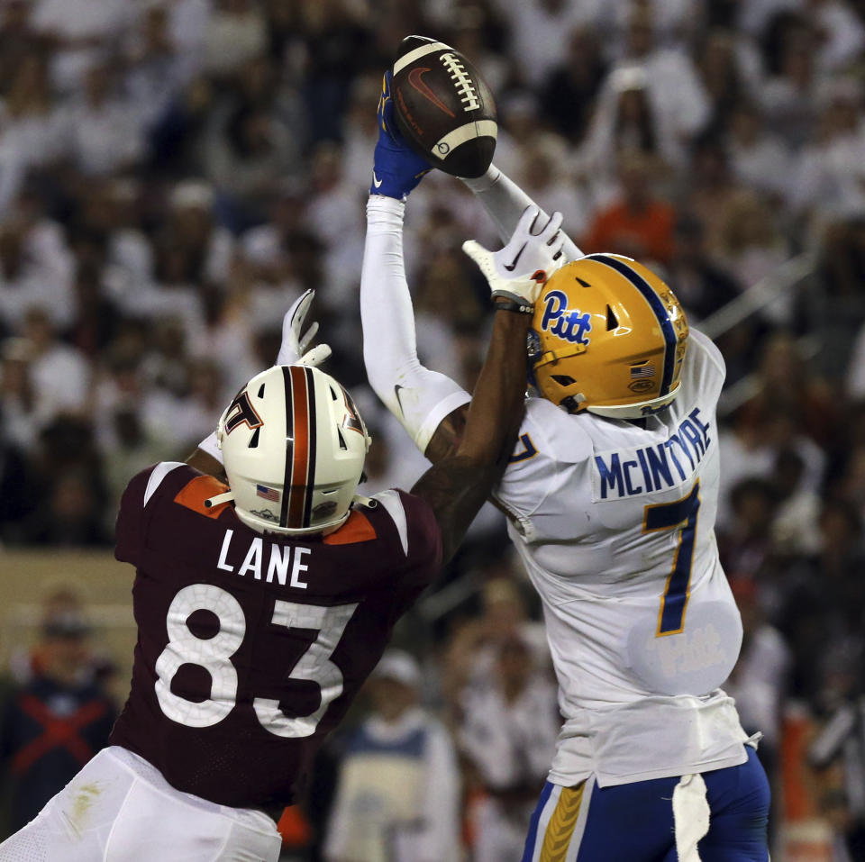 Pittsburgh defender Javon McIntyre (7) breaks up a pass intended for Virginia Tech wide receiver Jaylin Lane (83) during the first half of an NCAA college football game Saturday, Sept. 30, 2023, in Blacksburg, Va. (Matt Gentry/The Roanoke Times via AP)