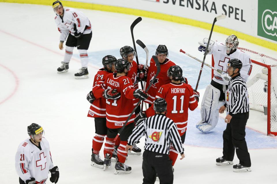 Canada celebrates a goal by Griffin Reinhart in front of Switzerland's goalie Melvin Nyffeler during the first period of their IIHF World Junior Championship ice hockey game in Malmo
