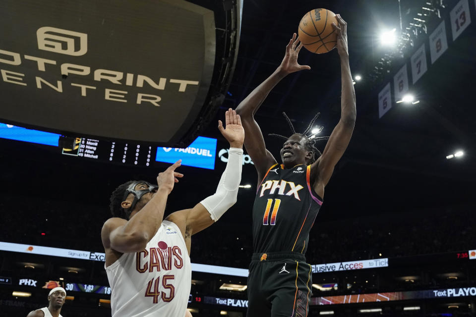 Phoenix Suns center Bol Bol (11) shoots over Cleveland Cavaliers guard Donovan Mitchell (45) during the first half of an NBA basketball game in Phoenix, Wednesday, April. 3, 2024. (AP Photo/Darryl Webb)