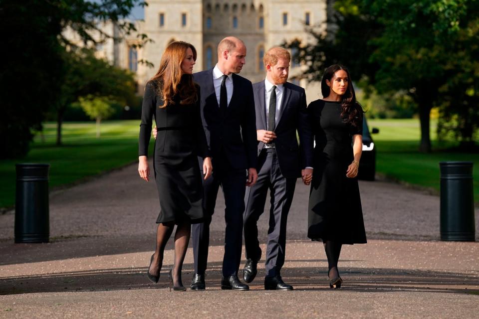 Kate, the Princess of Wales, Prince William, Prince of Wales, Prince Harry and Meghan, Duchess of Sussex walk to meet members of the public at Windsor Castle (AP)
