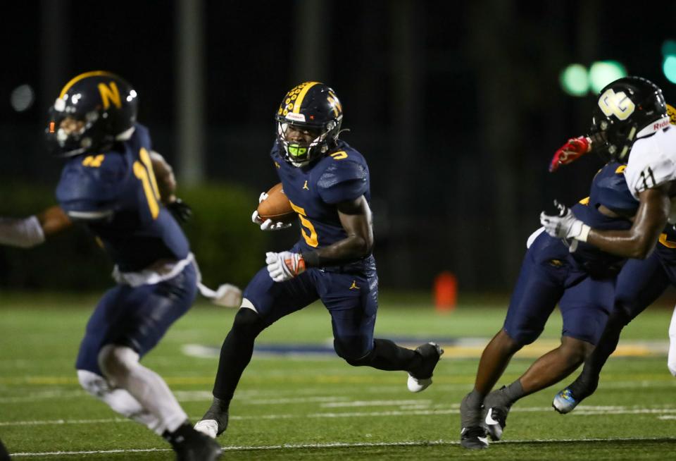 Naples Golden Eagles running back Shawn Simeon (5) runs the ball during the second quarter of a district game against the Golden Gate Titans at Staver Field in Naples on Thursday, Sept. 14, 2023.