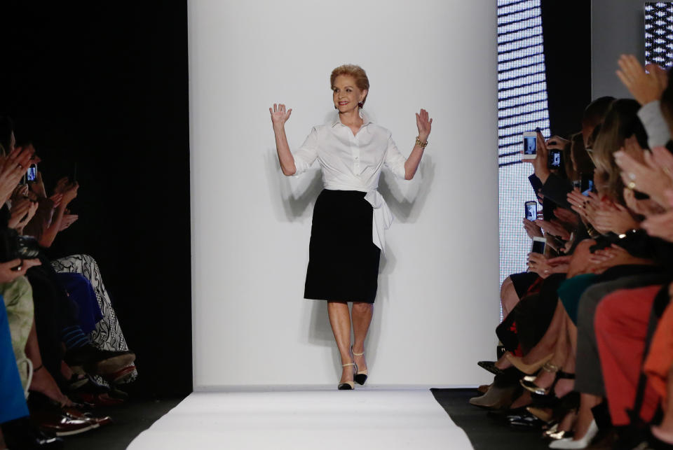 Designer Carolina Herrera acknowledges audience applause after her Spring 2014 collection was modeled during Fashion Week in New York, Monday, Sept. 9, 2013. (AP Photo/Richard Drew)