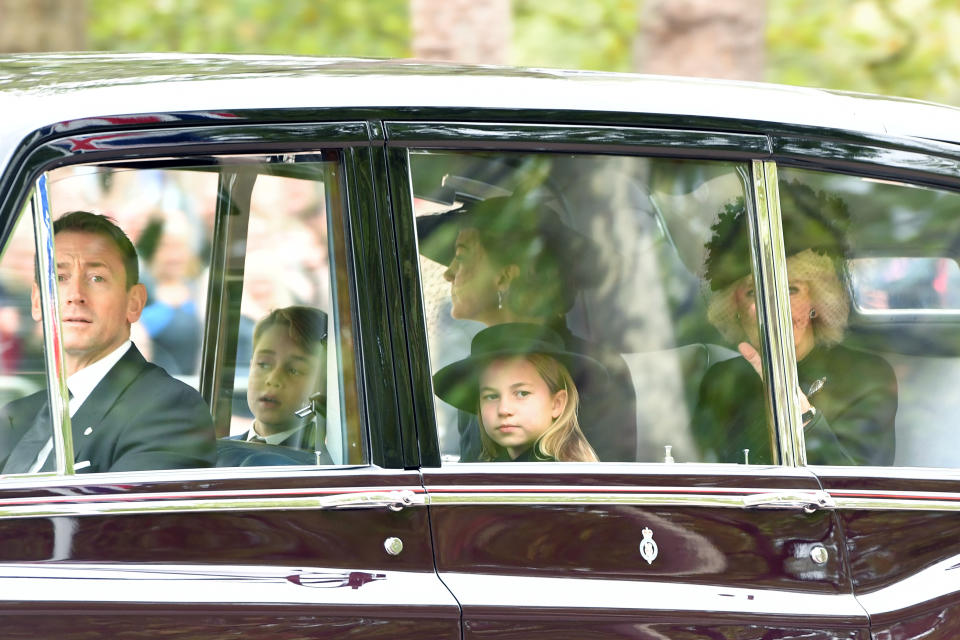LONDON, ENGLAND - SEPTEMBER 19: Prince George of Wales, Princess Charlotte of Wales, Catherine, Princess of Wales and Camilla, Queen consort are seen on The Mall ahead of The State Funeral for Queen Elizabeth II on September 19, 2022 in London, England. Elizabeth Alexandra Mary Windsor was born in Bruton Street, Mayfair, London on 21 April 1926. She married Prince Philip in 1947 and ascended the throne of the United Kingdom and Commonwealth on 6 February 1952 after the death of her Father, King George VI. Queen Elizabeth II died at Balmoral Castle in Scotland on September 8, 2022, and is succeeded by her eldest son, King Charles III.  (Photo by Anthony Devlin/Getty Images)