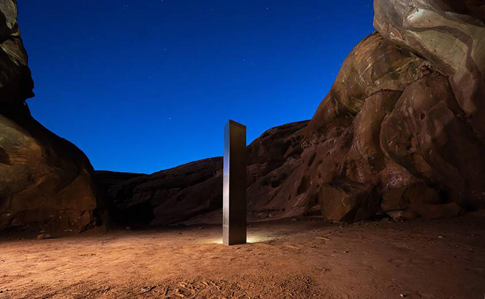 This Nov. 27, 2020 photo by Terrance Siemon shows a monolith that was placed in a red-rock desert in an undisclosed location in San Juan County southeastern Utah. New clues have surfaced in the disappearance of the gleaming monolith in Utah that seemed to melt away as mysteriously as it appeared in the red-rock desert. A Colorado photographer told a TV station in Salt Lake City that he saw four men push over the hollow, stainless steel structure in Utah on Friday night. (Terrance Siemon via AP)