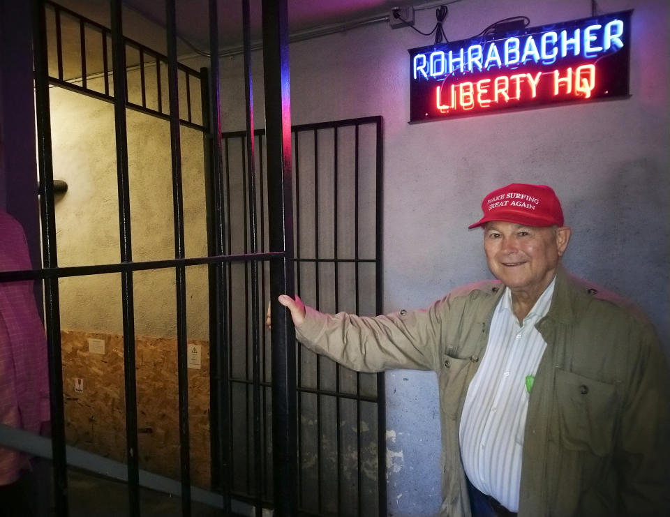 FILE - In this Tuesday, Nov. 6, 2018 file photo, U.S. Rep. Dana Rohrabacher, R-Costa Mesa, leaves the Rohrabacher's "Liberty Headquarters" set upstairs of the Skosh Monahan's Irish Pub in Costa Mesa, Calif. Along with Republican U.S. Rep. Mimi Walters loss Thursday, Nov. 15, 2018, in Orange County, 15-term Rep. Rohrabacher was ousted from his nearby district. The seat held by retiring Republican Rep. Darrell Issa, which cuts across the southern part of the county, was taken by Democrat Mike Levin, an environmental attorney. (AP Photo/Damian Dovarganes, File)