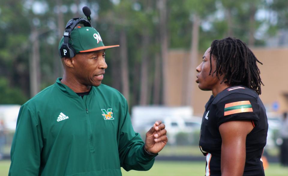 Drake Stubbs talks with a Mandarin coach during a jamboree with Mandarin, St. Augustine and Bishop Kenny on Wednesday.