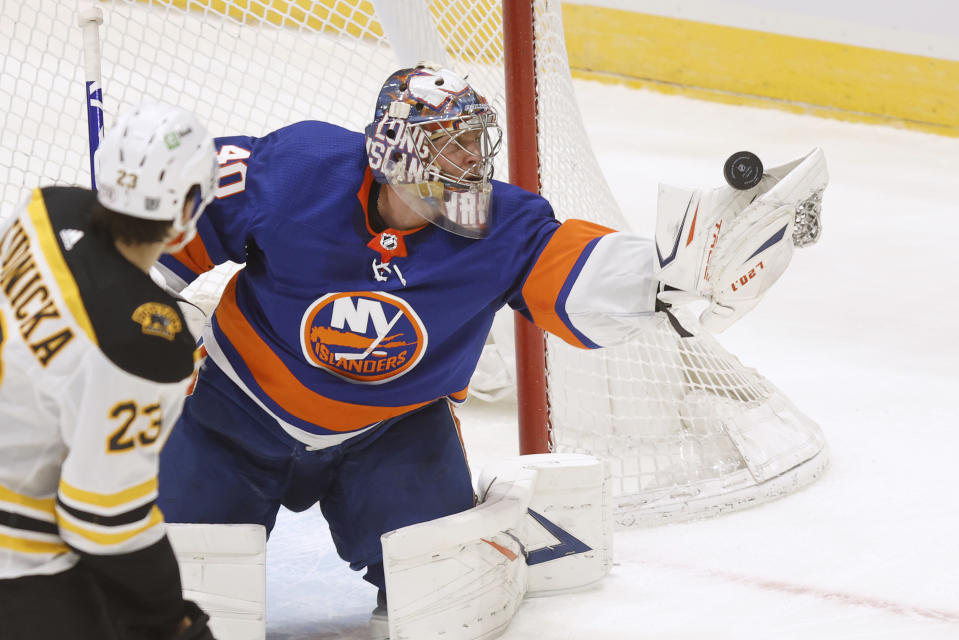 New York Islanders goalie Semyon Varlamov (40), of Russia, makes a glove-save against the Boston Bruins during the second period of an NHL hockey game Monday, Jan. 18, 2021, in Uniondale, N.Y. (AP Photo/Jason DeCrow)