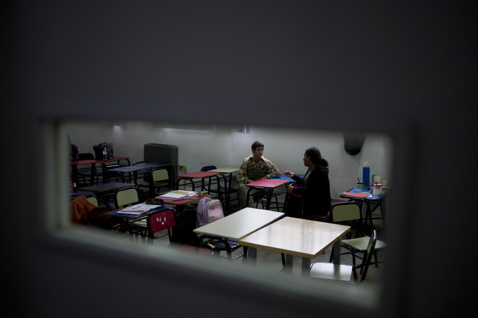 Luana Salva, who identifies as a trans woman, right, talks with classmate Mateo Ruffolo during a break at Mocha Celis, a transgender school where Salva is studying her last year of high school in Buenos Aires, Argentina, Tuesday, April 16, 2024. After being fired from her civil service job in a wave of government layoffs, the 43-year-old is considering returning to prostitution, saying it may be the only work she can find. (AP Photo/Natacha Pisarenko)