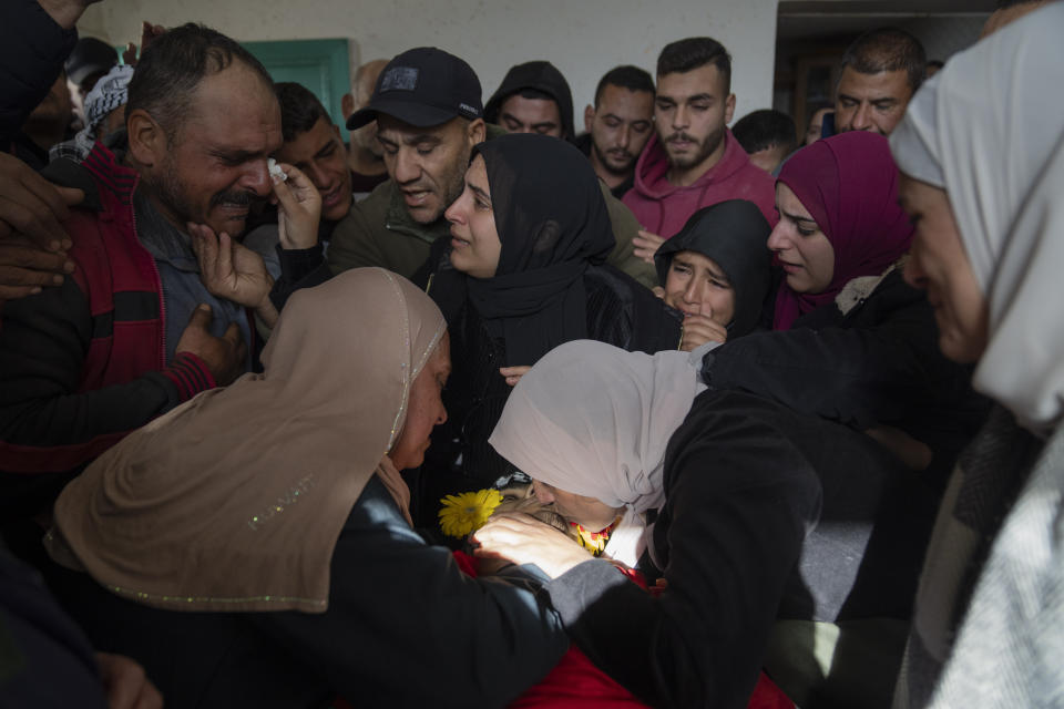 Mourners take the last look at the body of Palestinian Abdel Rahman Hamed, 18 during his funeral in the West Bank town of Silwad Monday, Jan. 29, 2024. Palestinian authorities say five Palestinians have been killed by Israeli forces in separate shootings across the occupied West Bank on Monday including Hamed who was killed during clashes with Israeli border police at his home village of Silwad. (AP Photo/Nasser Nasser)