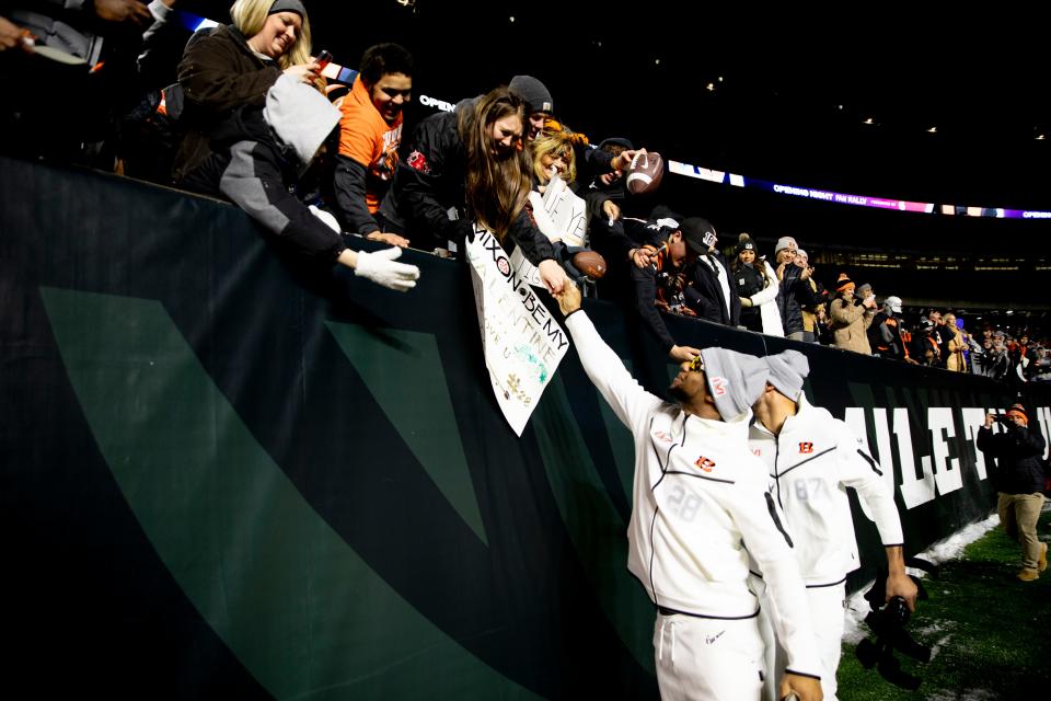 Cincinnati Bengals running back Joe Mixon (28) and Cincinnati Bengals tight end C.J. Uzomah (87) greet fans during the Super Bowl LVI Opening Night Fan Rally, Monday, Feb. 7, 2022, at Paul Brown Stadium in Cincinnati.