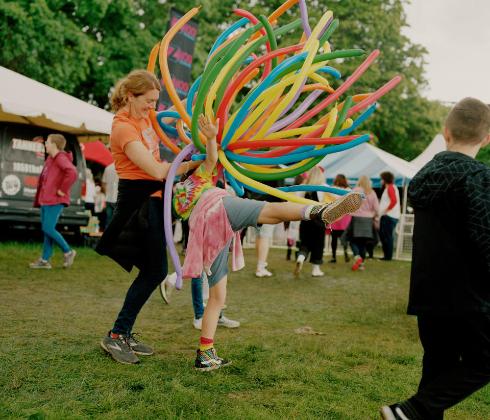 Karen and her kids play with balloons at Portland’s Pride festival on June 19, 2022.<span class="copyright">Ricardo Nagaoka for TIME</span>