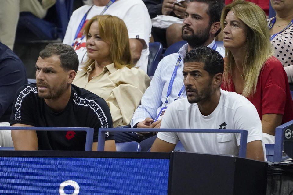 Karim Kamoun, left, Ons Jabeur's husband, and Issam Jellali, Jabeur's coach, watch play between Jabeur and Caroline Garcia, of France, during the semifinals of the U.S. Open tennis championships, Thursday, Sept. 8, 2022, in New York. (AP Photo/John Minchillo)