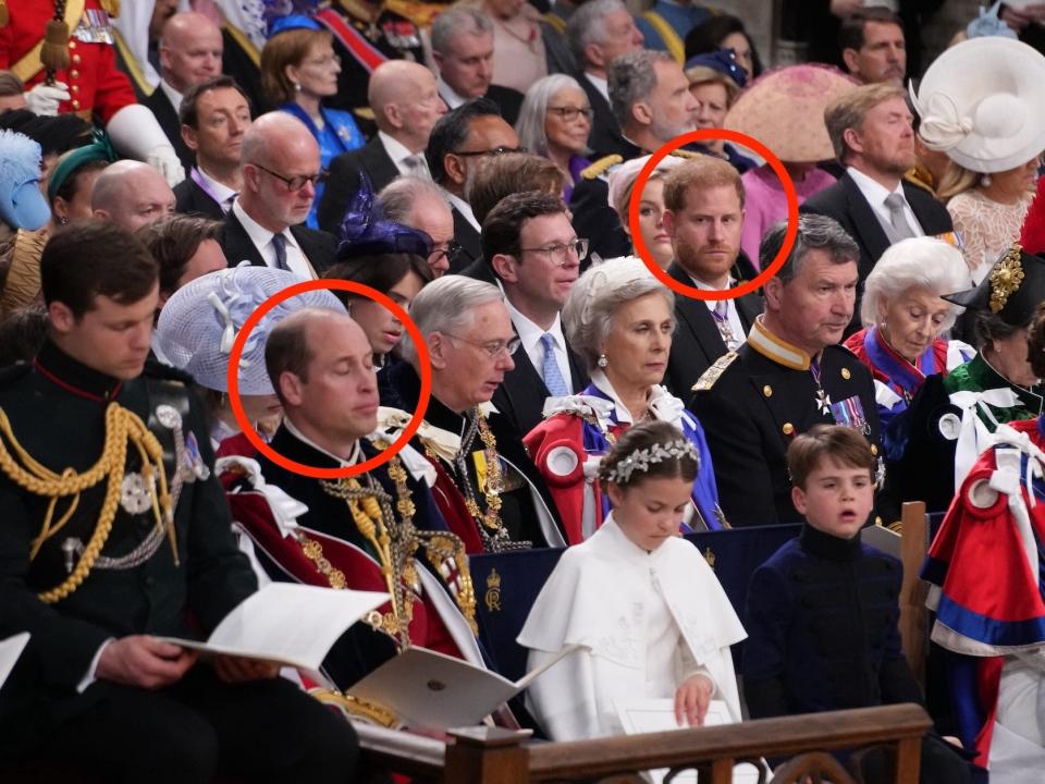 Prince Harry looks towards Prince William at King Charles III's coronation.