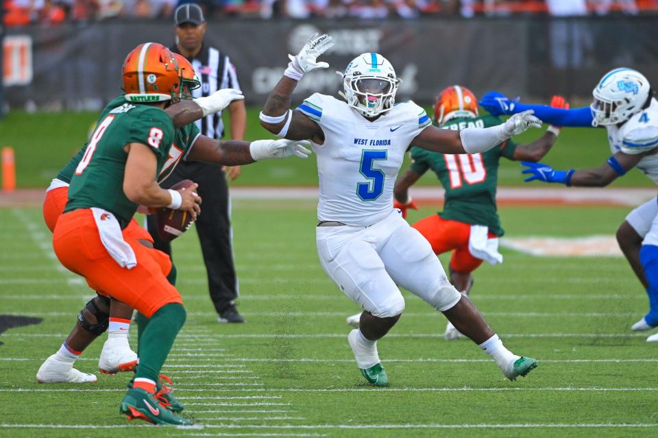 UWF's John McMullen (5) chases after quarterback Jeremy Moussa (8) during the Argos' 31-10 loss at Florida A&M University at Ken Riley Field at Bragg Memorial Stadium on Saturday, Sept. 16, 2023.