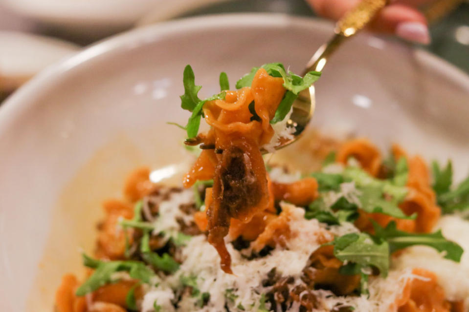 a close up of ragu campanelle