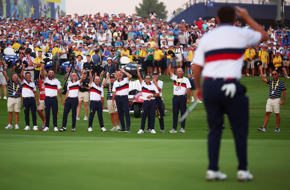 The U.S. team doffs its cap to Patrick Cantlay (foreground). (Maddie Meyer/PGA of America/PGA of America via Getty Images)