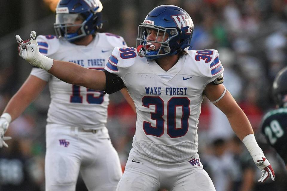 Wake Forest’s Zane Williams (30) motions to the sidelines between downs against Leesville Road. The Wake Forest Cougars and the Leesville Road Pride met in a football game in Raleigh, N.C. on September 15, 2023.