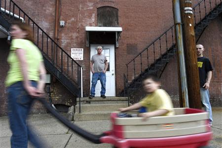 Bruce Zigarski (C), 60, a retired heavy equipment operator, stands on the steps of his apartment building, in Shamokin May 1, 2014. REUTERS/Mark Makela