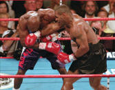 <p>Mike Tyson, right, lands a right to the face of WBA heavyweight champion Evander Holyfield during the third round, Saturday night, June 28, 1997, at the MGM Grand Garden in Las Vegas. Tyson was leading in the round until he lost two points for biting Holyfield’s ear and pushing him. He was later disqualified in the round after biting Holyfield’s other ear. (AP Photo/Lennox McLendon) </p>